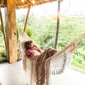 woman in hammock in tropical location on vacation