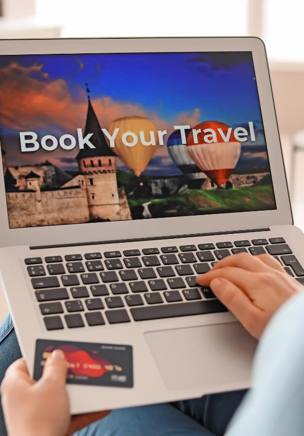 person on laptop booking a vacation