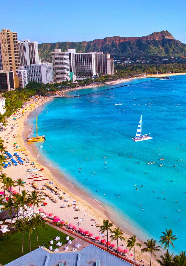 hawaii beach with condos and sailboats