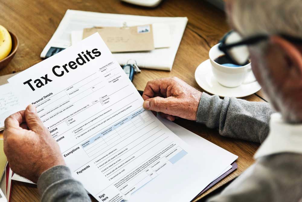 photo of man holding tax credits form