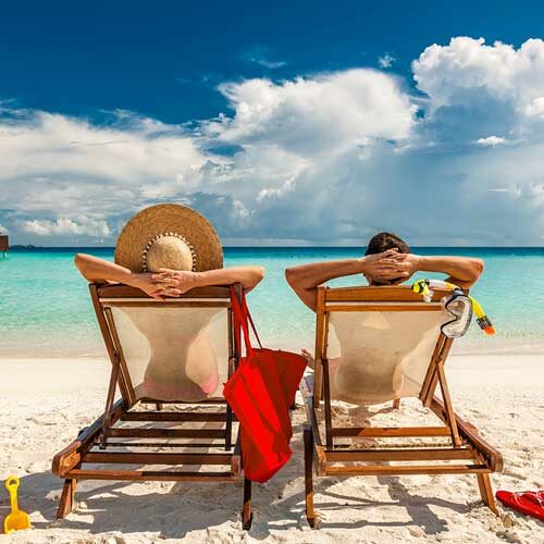 luxury vacationers sitting on chairs on a beach